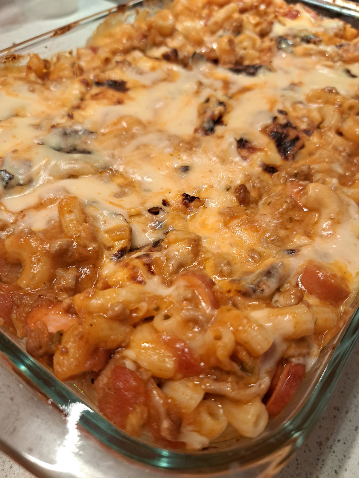 Close-up of baked macaroni with ground meat and melted cheese