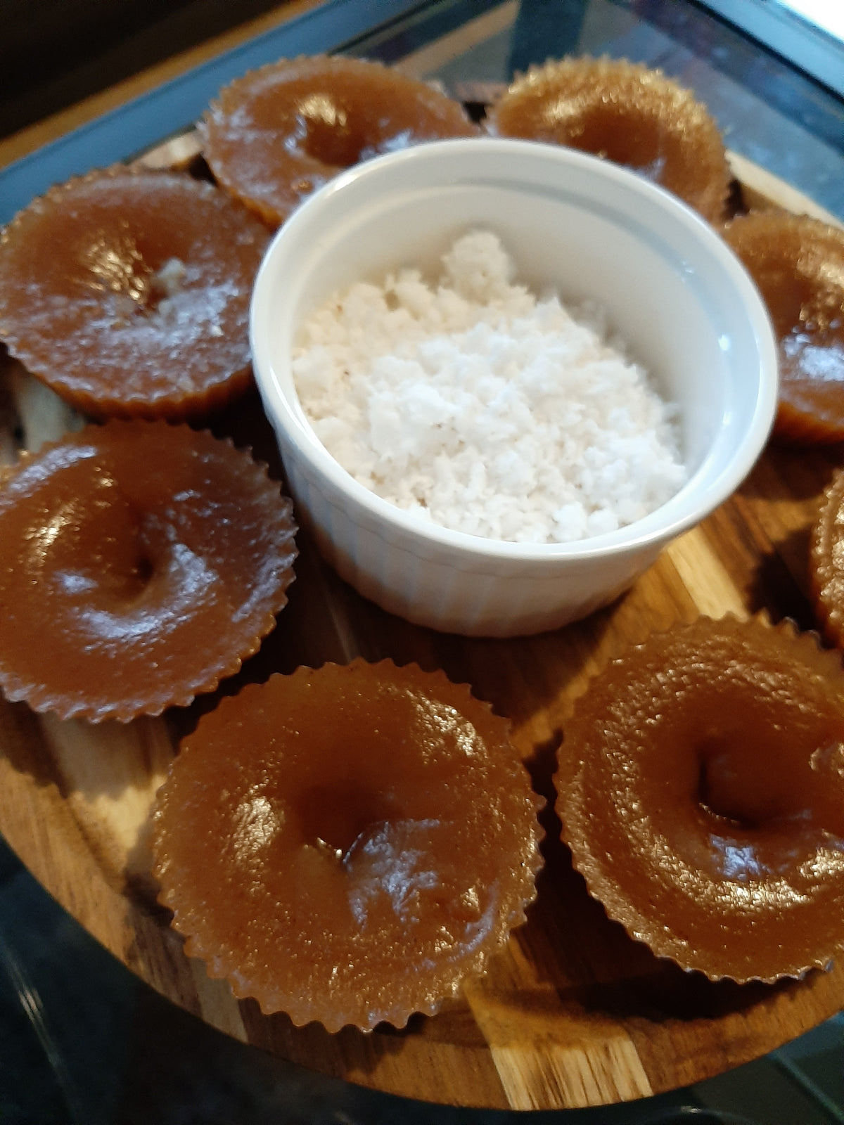 Filipino kutsinta arranged around a bowl of grated coconut