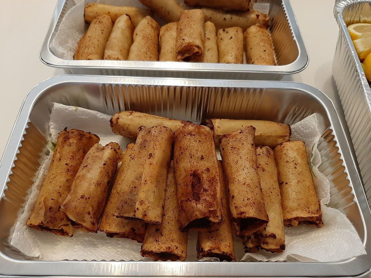 Two trays of lumpia Shanghai ready for a Filipino party spread