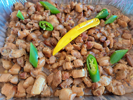 Bicol Express pork with green and yellow chillies in a catering tray