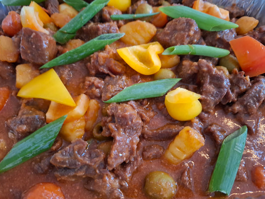 Filipino beef kaldereta with vegetables in a rich savoury sauce