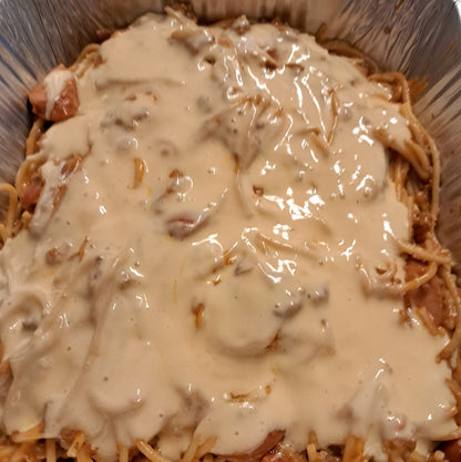 Close-up of creamy cheese-topped sweet-style Filipino spaghetti