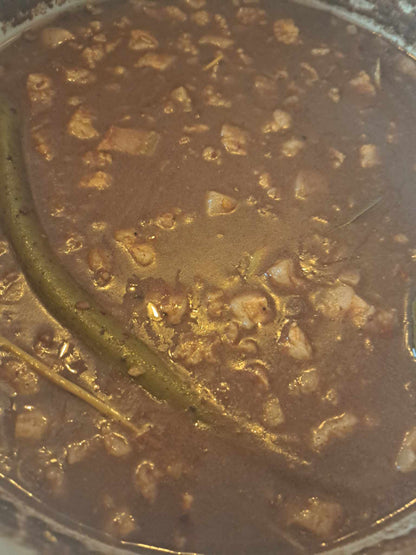 Close-up of freshly cooked dinuguan pork blood stew with green chillies