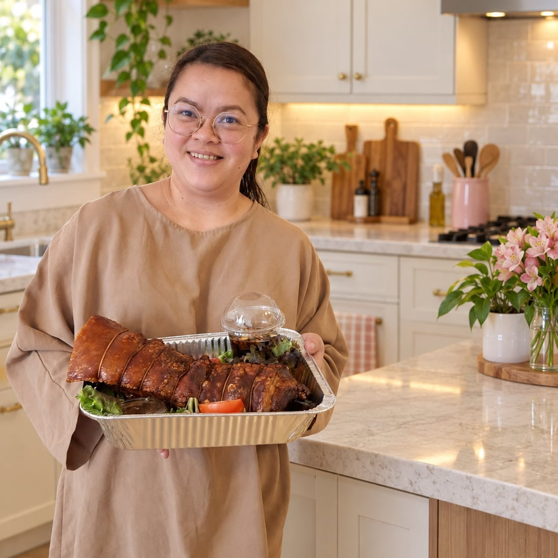 Venus holding a tray of sliced lechon belly in a bright kitchen