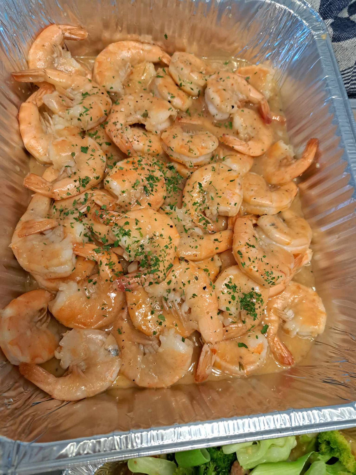 Tray of garlic buttered shrimp garnished with parsley