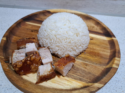 Air-fried lechon kawali served with steamed rice on a wooden plate