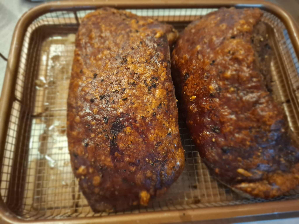 Two pieces of air-fried lechon kawali with crispy golden skin