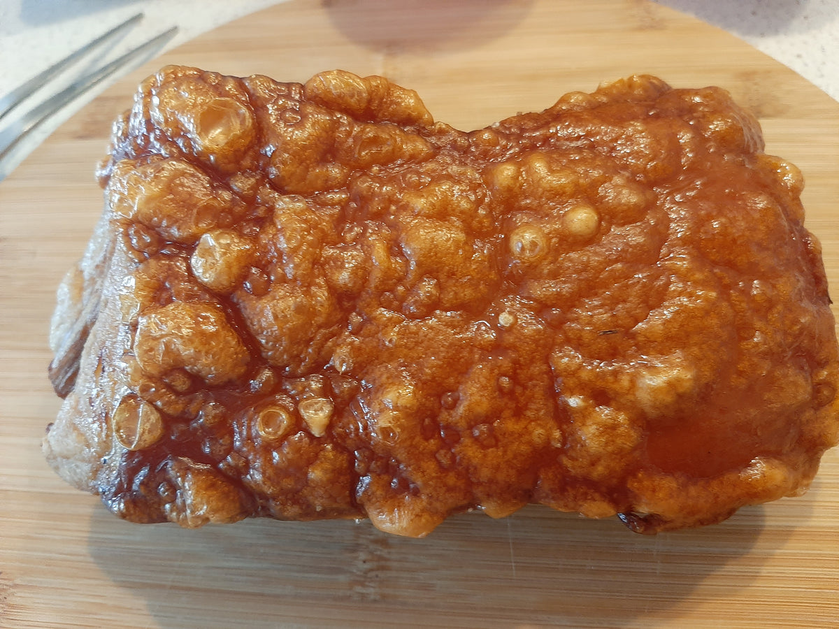 Crispy air-fried lechon kawali on a wooden plate