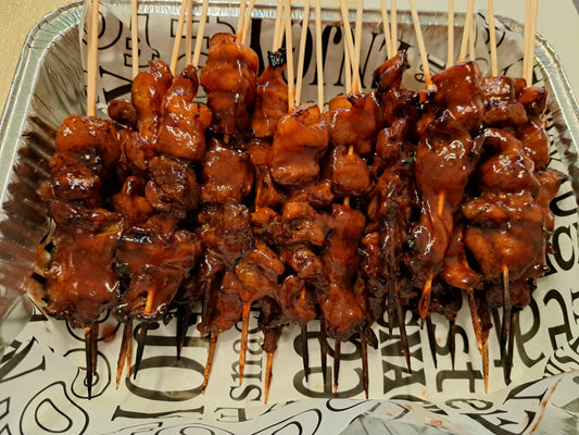 Grilled Filipino pork barbecue skewers arranged in a serving tray