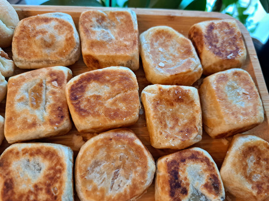 Golden-brown classic Filipino hopia on a wooden serving tray