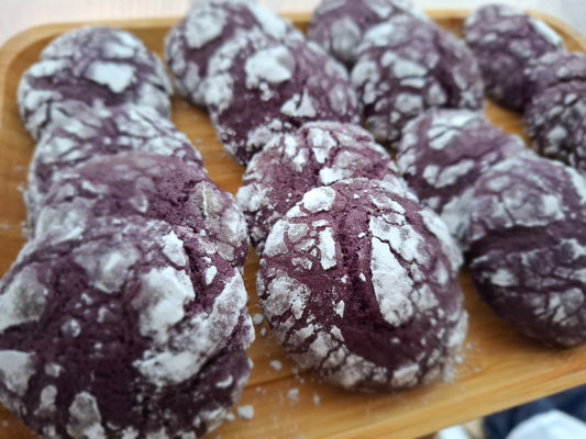 Homemade ube crinkle cookies coated with powdered sugar
