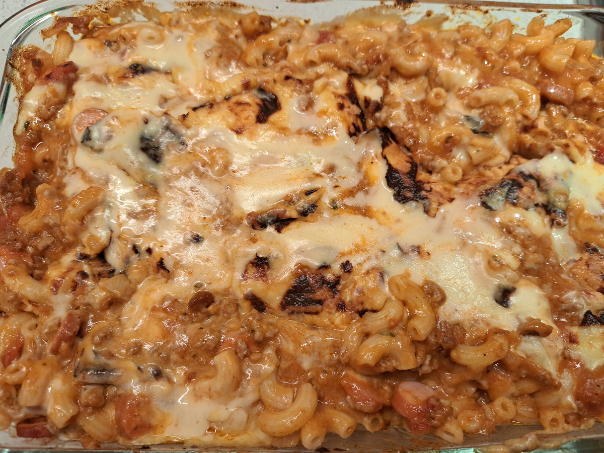 Homemade baked macaroni topped with melted golden cheese