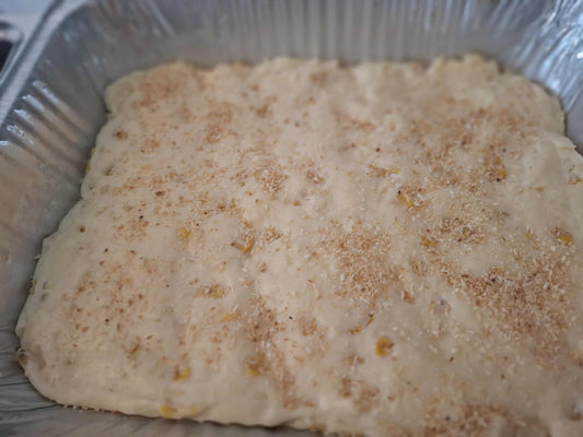 Filipino maja blanca dessert with toasted coconut in a foil tray