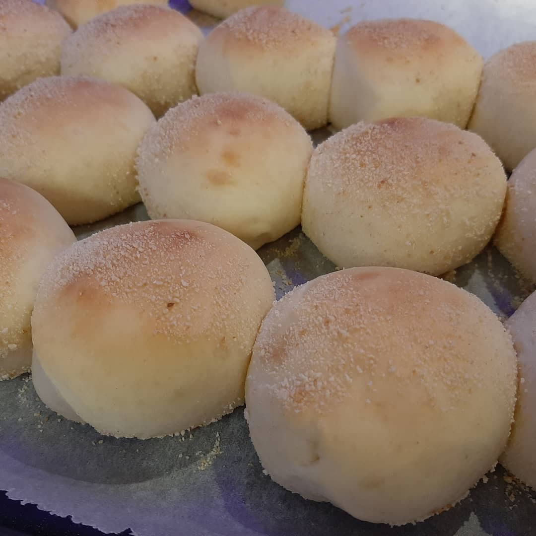 Close-up of soft classic pandesal rolls on a baking tray