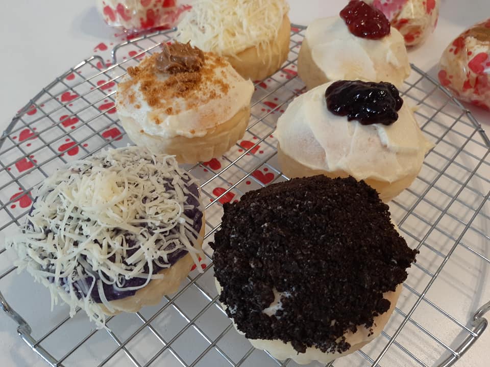 Six assorted special ensaymada cooling on a wire rack