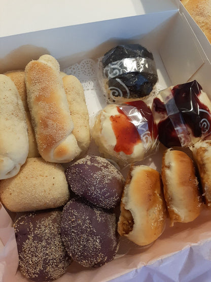 Mixed bread box with long rolls, ube buns and topped ensaymada