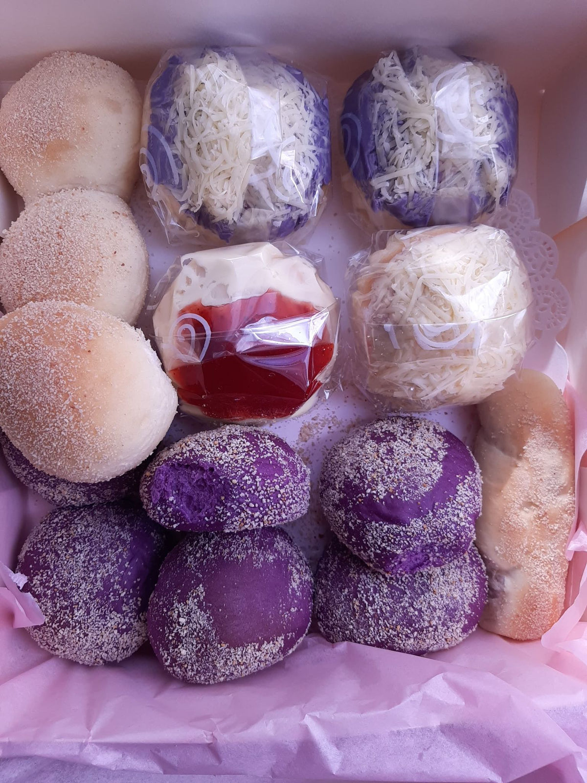 Filipino bread assortment featuring ube pandesal and special ensaymada