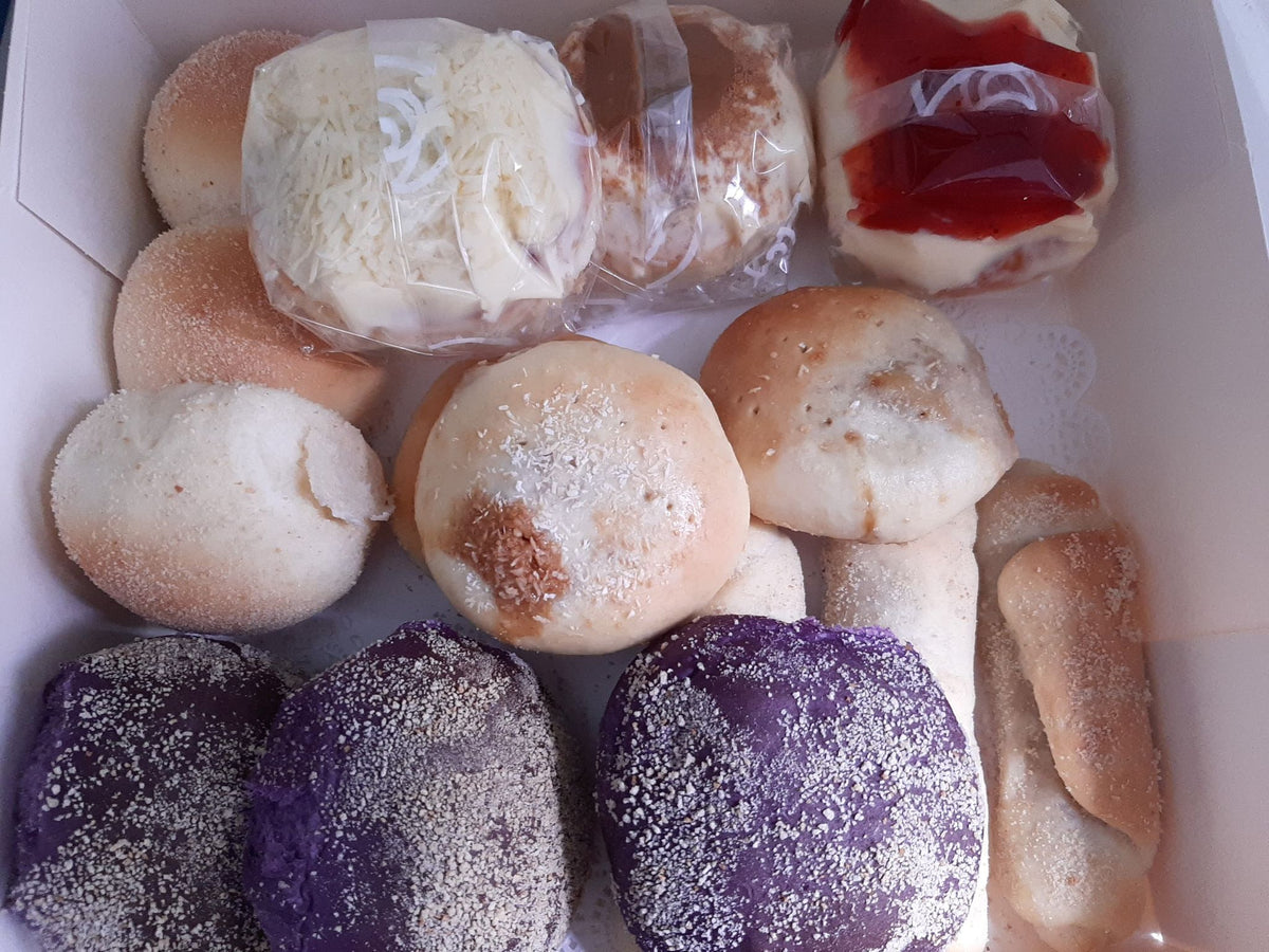 Assorted bread box with cheese-topped buns, ube rolls and sweet breads