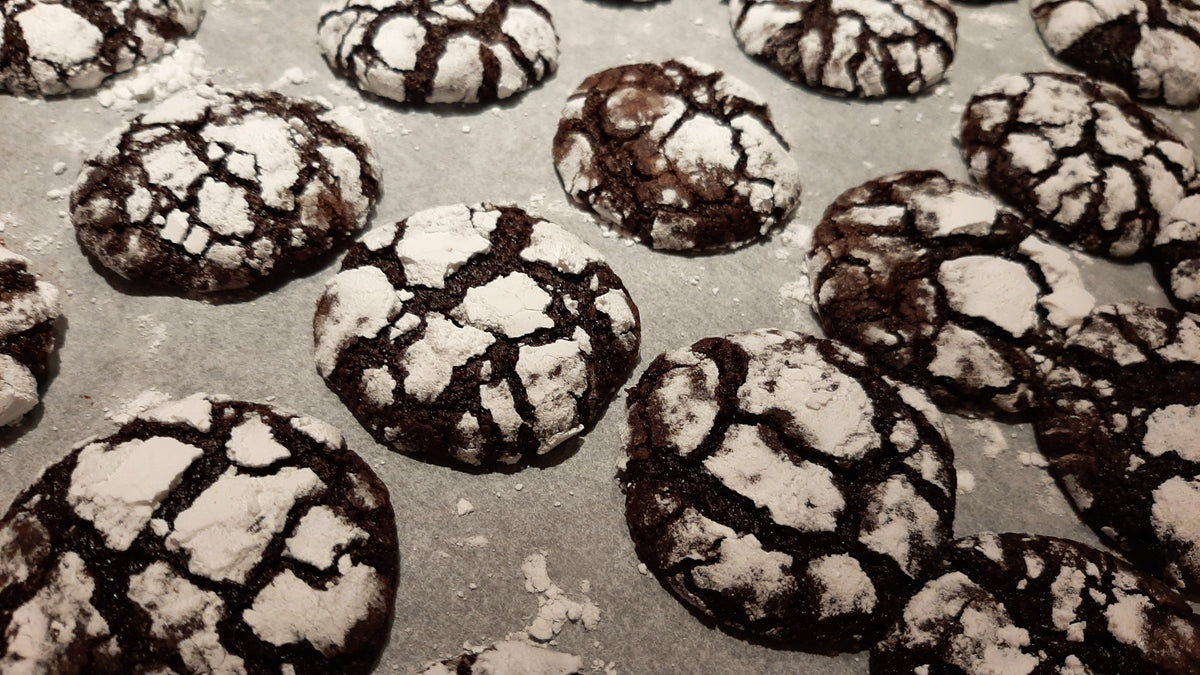 Tray of freshly baked choco crinkles dusted with powdered sugar