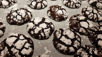 Tray of freshly baked choco crinkles dusted with powdered sugar
