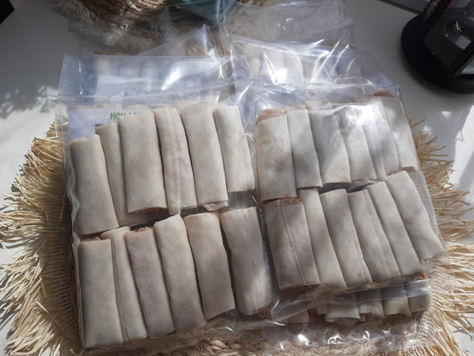 Uncooked pork mini lumpia arranged in sealed freezer bags