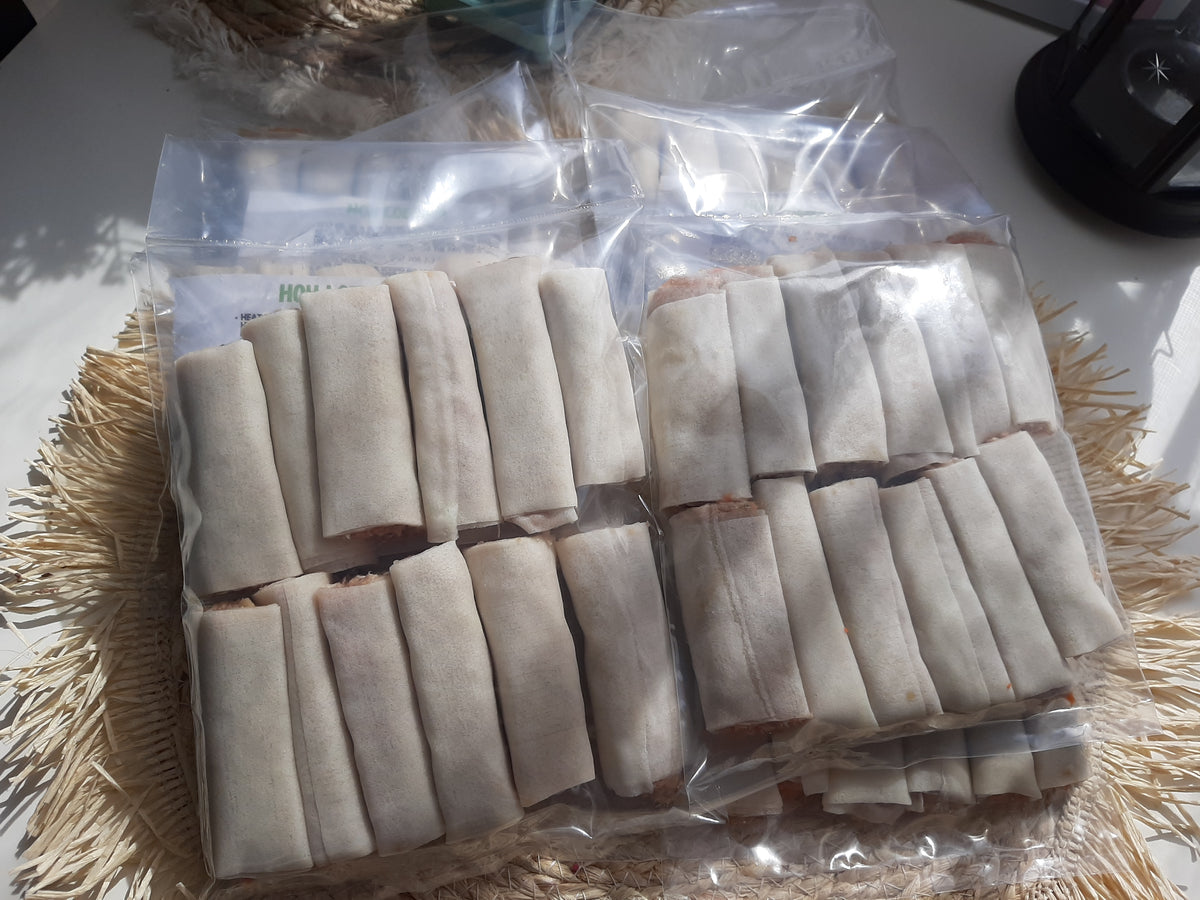 Uncooked chicken mini lumpia arranged in sealed freezer bags