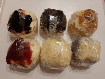 Overhead view of six individually wrapped special ensaymada flavours