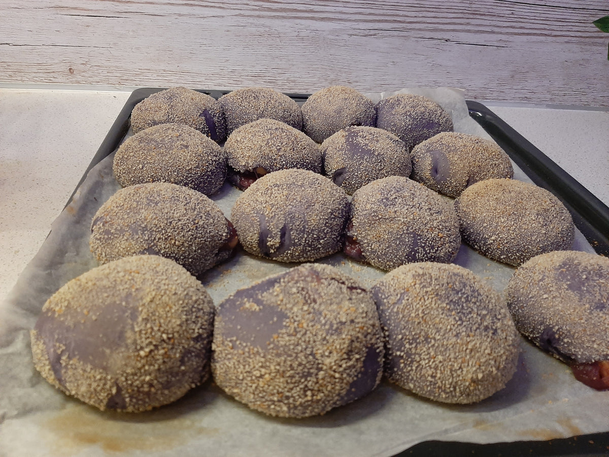 Large batch of breadcrumb-coated ube cheese pandesal