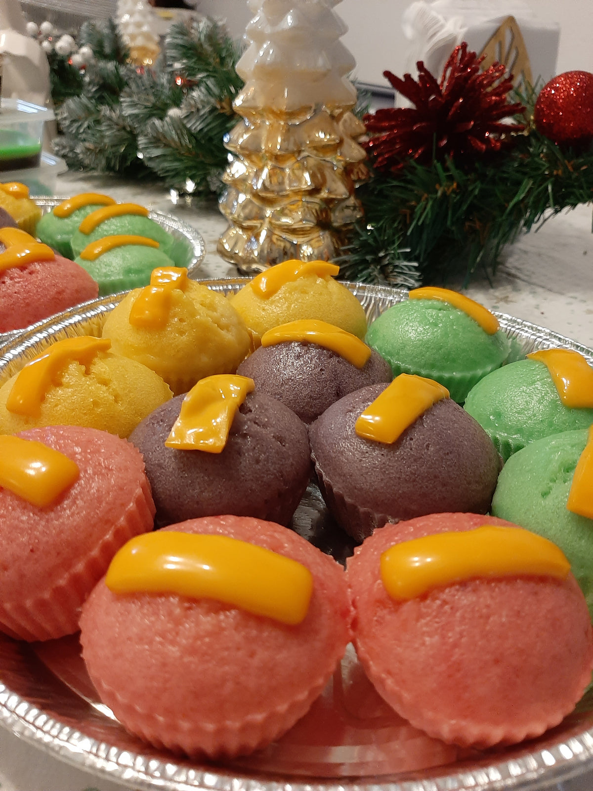 Close-up of festive puto cheese in four colours with cheese topping