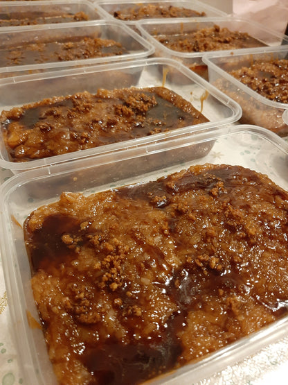 Rows of biko bibingka malagkit tubs with caramel coconut topping