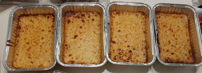 Four Filipino cassava cakes baked in individual takeaway tubs