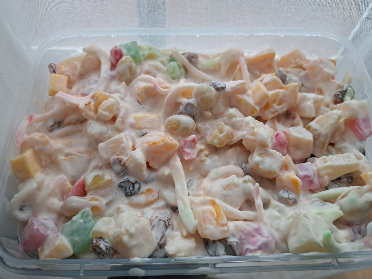 Creamy Filipino fruit salad with mixed fruit, raisins and coconut strips