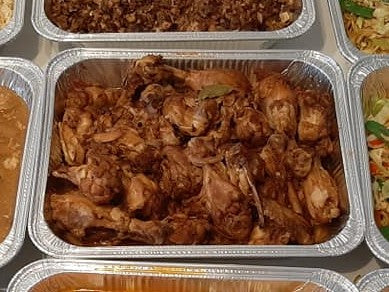 Chicken adobo served in a foil catering tray
