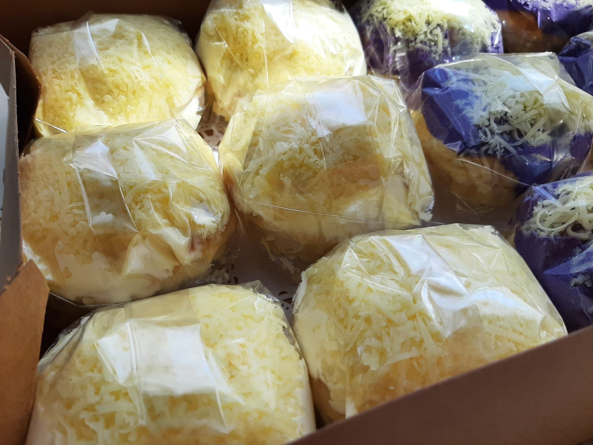 Close-up of wrapped cheese-topped special ensaymada in a box