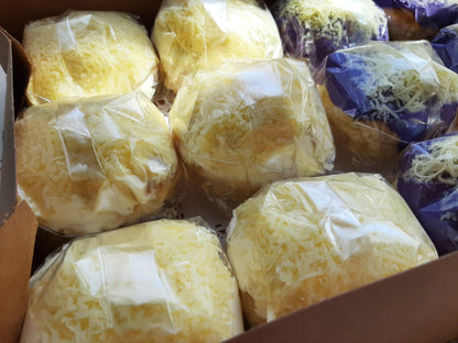 Close-up of wrapped cheese-topped special ensaymada in a box