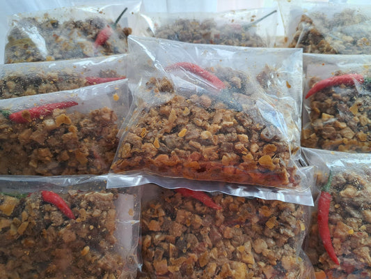 Frozen 200 g pork sisig portions sealed in clear packs with red chillies