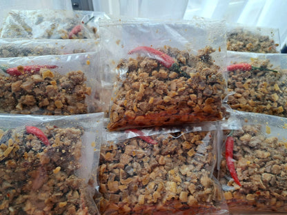 Multiple frozen pork sisig 200 g packs with red chilli garnish