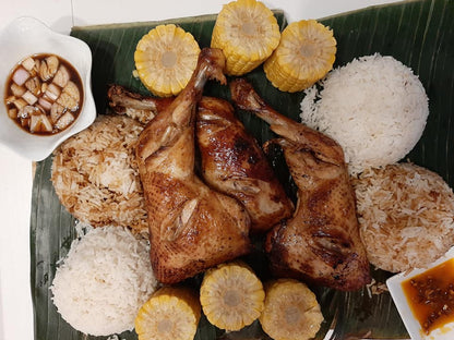 Overhead baked chicken inasal platter with rice, corn and dipping sauces