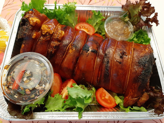 Roasted Filipino lechon belly roll served with salad and dipping sauces