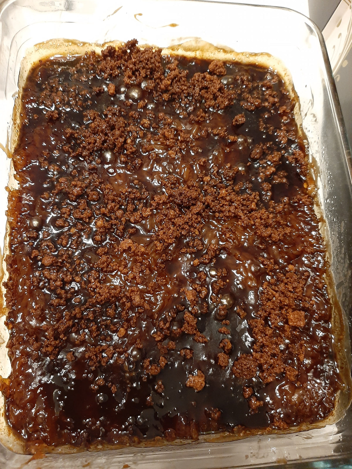 Overhead view of caramel-topped biko bibingka malagkit in a glass tray