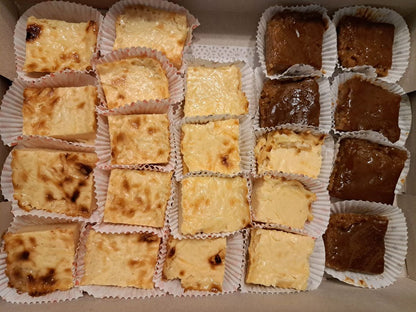 Assorted cassava cake squares with golden and caramelised tops in a box