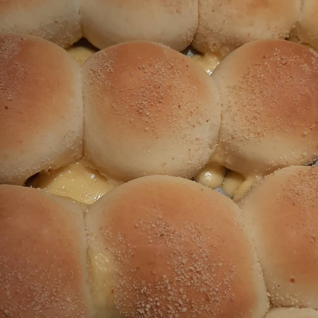 Close-up of warm cheese pandesal with melted filling between the rolls