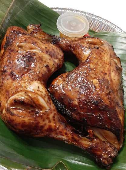 Close-up of two golden-brown baked chicken inasal thighs