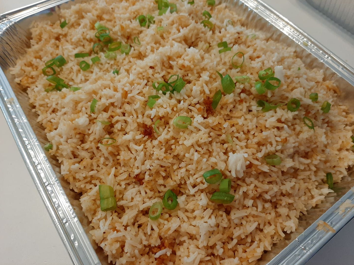 Close-up of fluffy garlic rice with chopped spring onion garnish