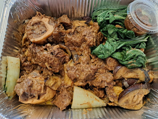 Beef kare-kare with bok choy, aubergine and shrimp paste in a tray