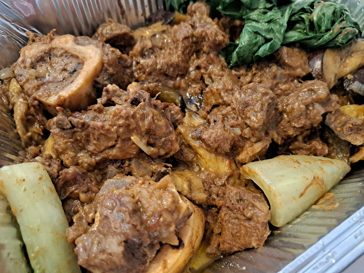 Close-up of tender beef and marrow bones in kare-kare peanut sauce