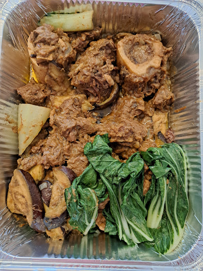 Full tray of beef kare-kare with bok choy and aubergine