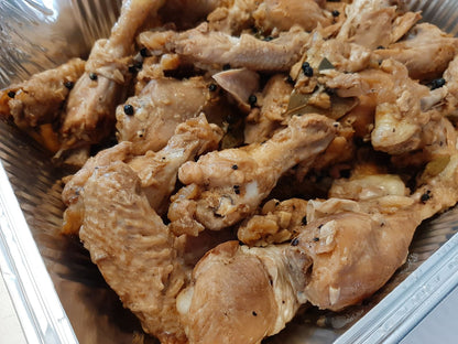 Close-up of tender chicken adobo with peppercorns and bay leaves