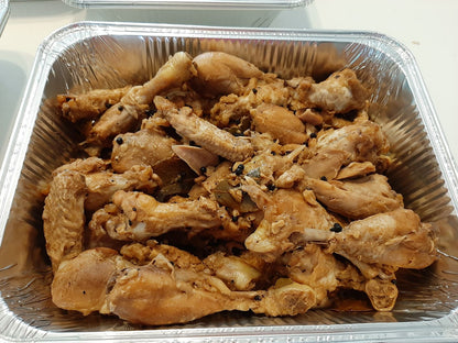 Large tray of chicken adobo pieces cooked in a light savoury sauce