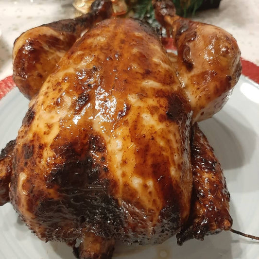 Close-up of Filipino lechon manok with glossy golden-brown roasted skin